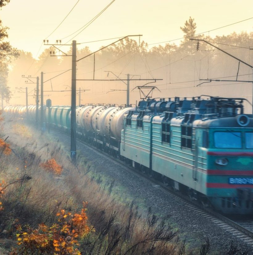 moving-freight-train-in-beautiful-forest-in-fog-at-sunrise.jpg